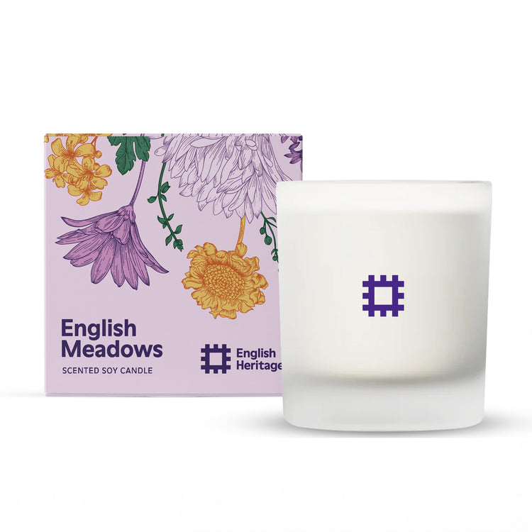 The English Heritage English Meadows floral candle by Home County Co. is shown next to its illustrated candle box.