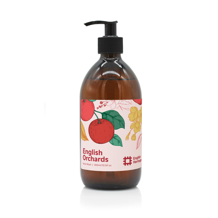 An English Heritage English Orchards apple scented hand wash in amber glass bottle with black lotion pump and apple illustrated label