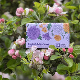 An English Heritage English Meadows soap bar is shown in a blossom tree