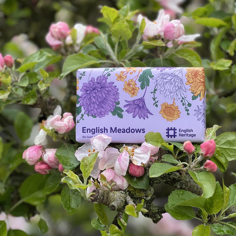 An English Heritage English Meadows soap bar is shown in a blossom tree