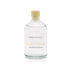 A freshly cut grass scented reed diffuser refill from the Home County Co is shown in its recyclable glass refill bottle.