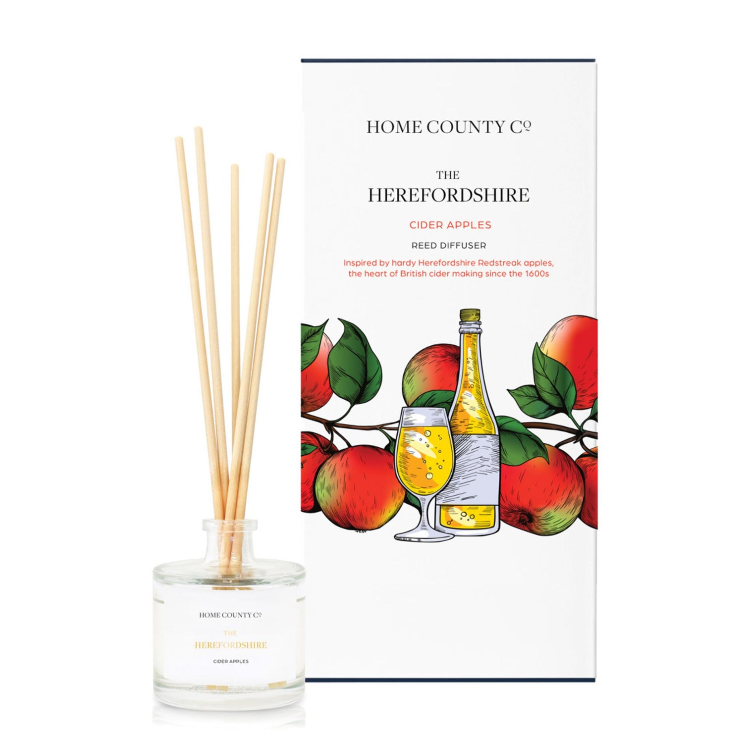A cider apple scented reed diffuser from Home County Co. The vegan friendly reed diffuser is shown next to the eco friendly reed diffuser box packaging.