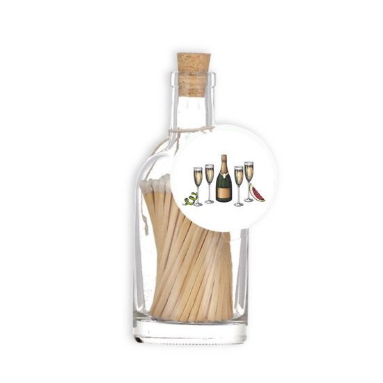A luxury glass match bottle from the Home County Co. with champagne bottle illustrated gift tag.