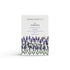 A Norfolk lavender scented natural soap bar from the Home County Co. is shown in its lavender illustrated recyclable soap bar wrap
