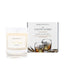 An Irish whiskey scented soy wax candle inspired by County Antrim is shown next to its sustainable candle box with whiskey illustration