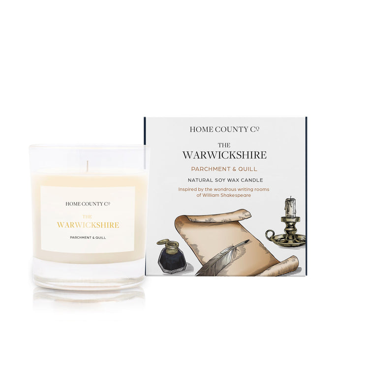 A parchment and quill scented soy wax candle inspired by Warwickshire is shown next to its sustainable candle box with parchment and quill illustration