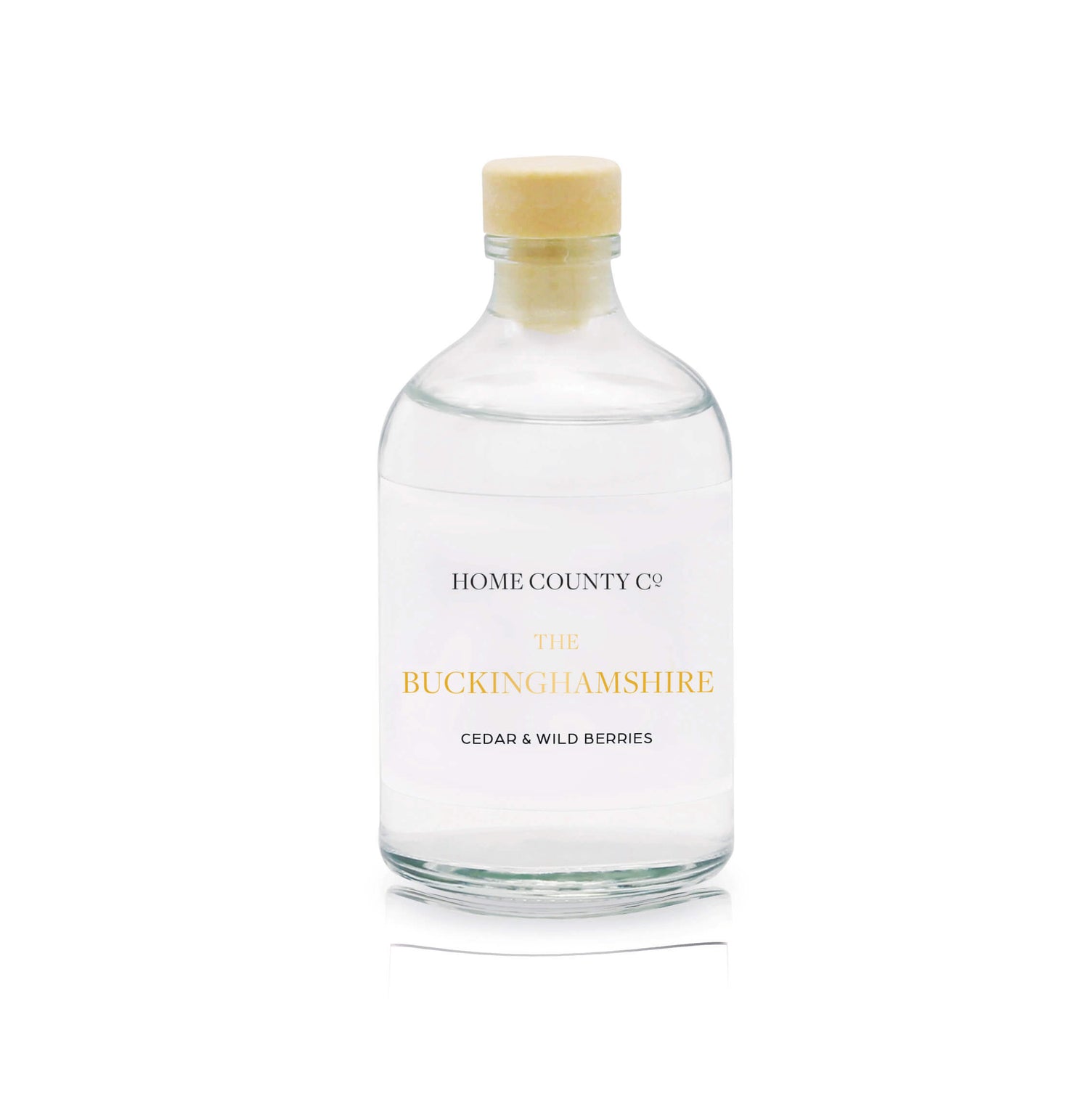 A cedar and wild berries reed diffuser refill is shown in a recyclable glass bottle