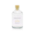 A sage and sea salt reed diffuser refill is shown in a recyclable glass bottle