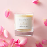 Home County Co. Berkshire rose scented candle shown with pink rose petals