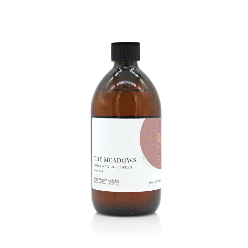A 500ml floral peony and wildflowers scented liquid hand wash refill from the Home County Co. is shown in its eco-friendly amber glass bottle