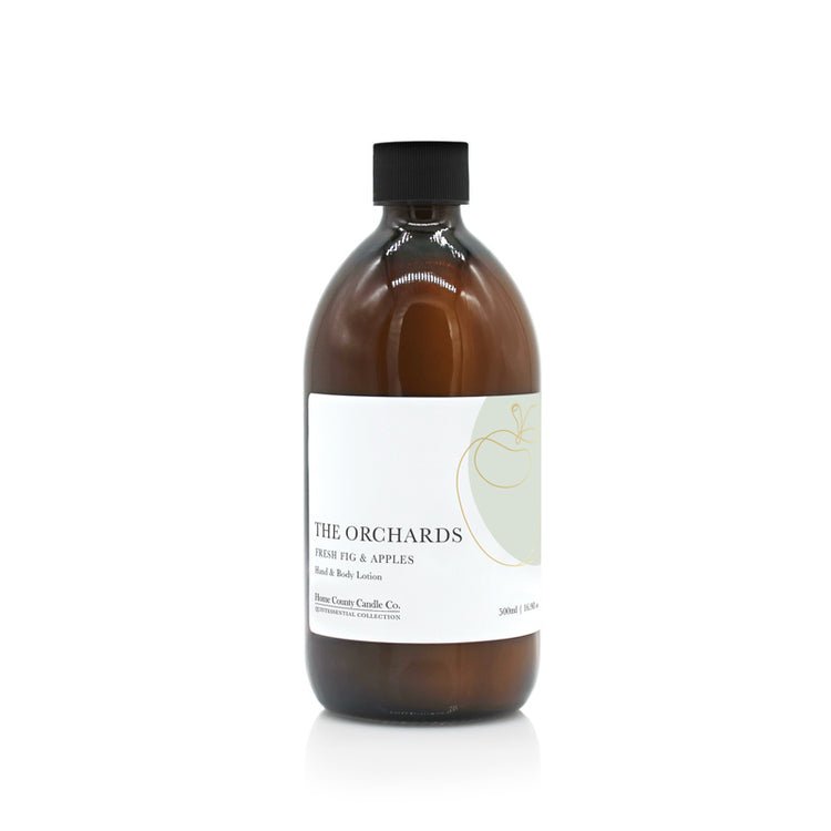 A 500ml fresh fig and apples scented hand and body lotion from the Home County Co. is shown in its eco-friendly amber glass bottle
