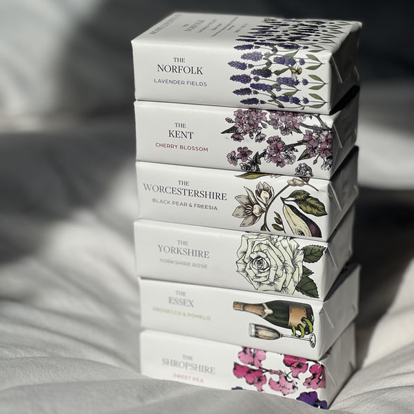 A stack of Home County Co. county collection soap bars.