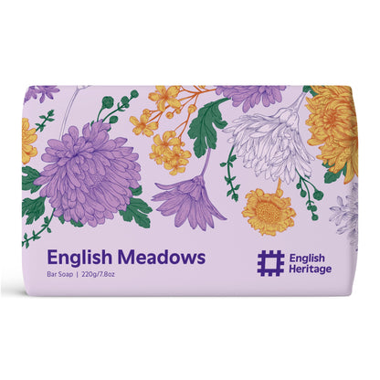 An English Heritage soap bar scented with English Meadows is shown in its floral illustrated paper soap wrap