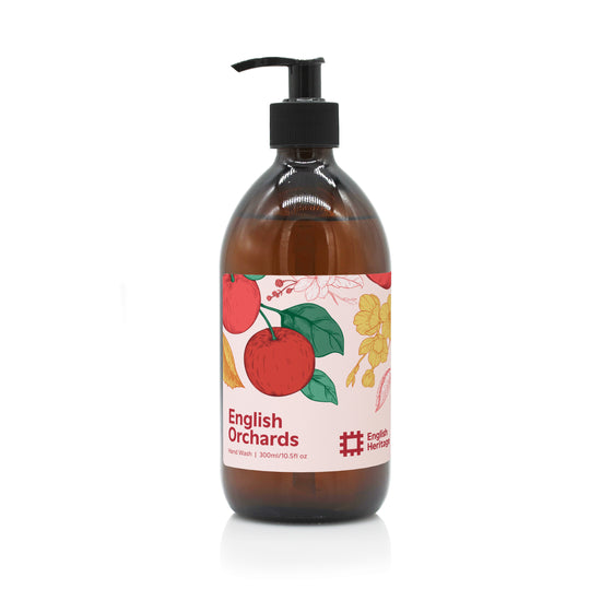 An English Heritage English Orchards apple scented hand wash in amber glass bottle with black lotion pump and apple illustrated label