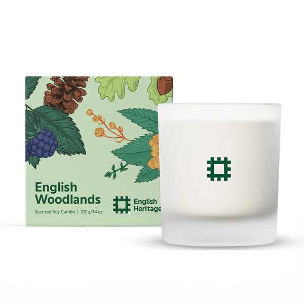 An English Heritage English Woodlands candle is shown next to its illustrated candle box.