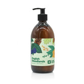 An English Heritage English Woodlands scented moisturising hand and body lotion in amber glass bottle with black lotion pump and woodland illustrated label