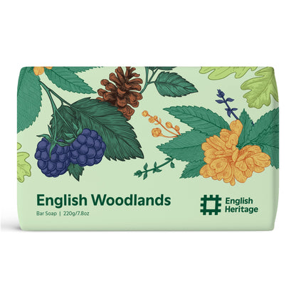 An English Heritage English Woodlands scented soap bar is shown in its woodland illustrated eco-friendly soap wrap