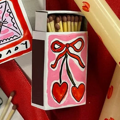 A mini Valentine's themed matchbox hand-painted by Eleanor Joanna with a love heart design