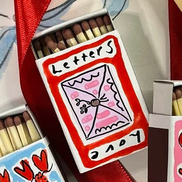 A mini matchbox, hand-painted by Eleanor Joanna with a love letters Valentine&