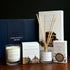 Home County Co. County Collection Gift Set shows an Edinburgh candle, argyll reed diffuser and deryshire soap bar in front of the luxury navy gift set box