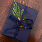 Home County Co. gift set with Christmas gift wrap - navy wrapping paper with a dried orange slice, cinnamon stick and a sprig of fir