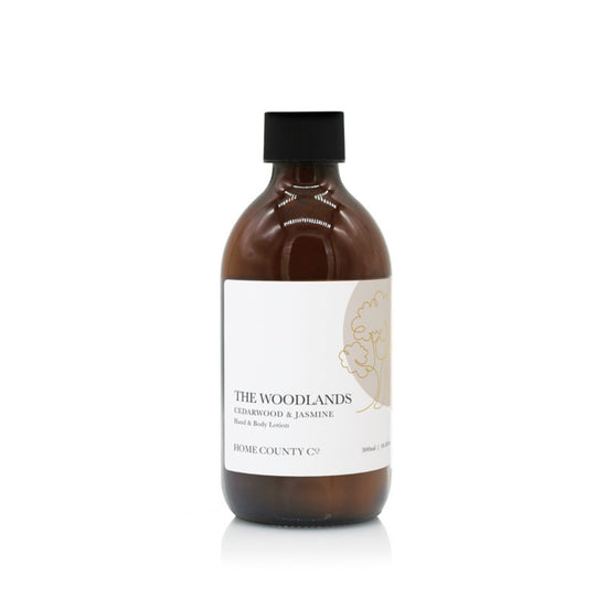 A 300ml woody cedarwood and jasmine scented hand and body lotion from the Home County Co. is shown in its eco-friendly amber glass bottle