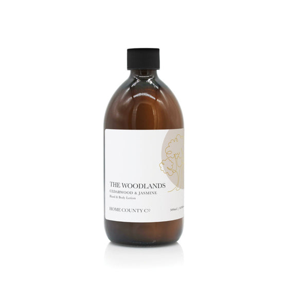 A 500ml woody cedarwood and jasmine scented hand and body lotion from the Home County Co. is shown in its eco-friendly amber glass bottle