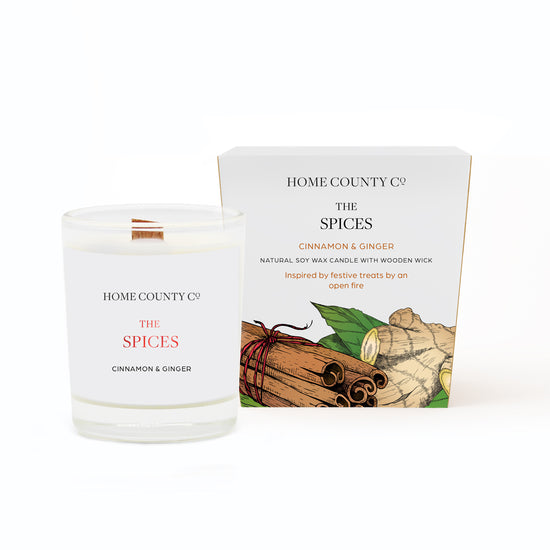 A cinnamon and ginger votive Christmas candle from the Home County Co. is shown in eco-friendly packaging