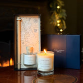 A Home County Co. Candle and Reed Diffuser Gift Set is shown in front of an open fire with the luxury navy gift box