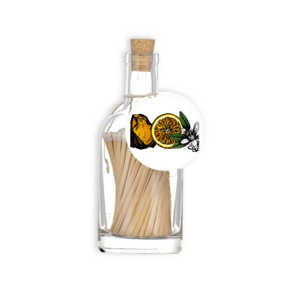 A luxury glass match bottle from the Home County Co. with Amber and Orange illustrated gift tag.