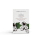 A clean cotton scented natural soap bar from the Home County Co. is shown in its cotton illustrated recyclable soap bar wrap