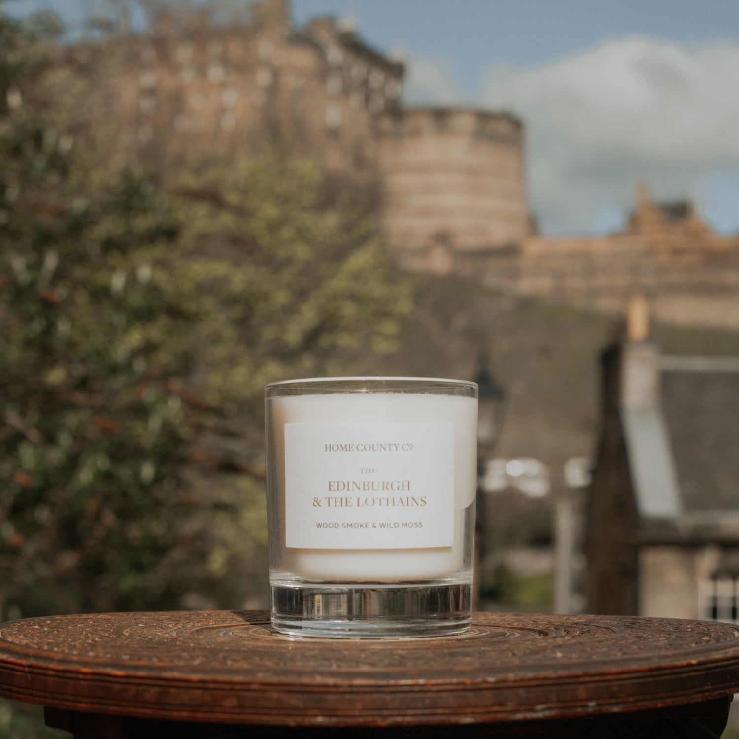 Home County Co. Edinburgh Candle is shown outside on the streets of Edinburgh