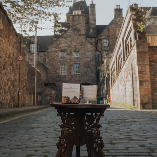 Home County Co. Edinburgh Candle is shown on the streets of Edinburgh