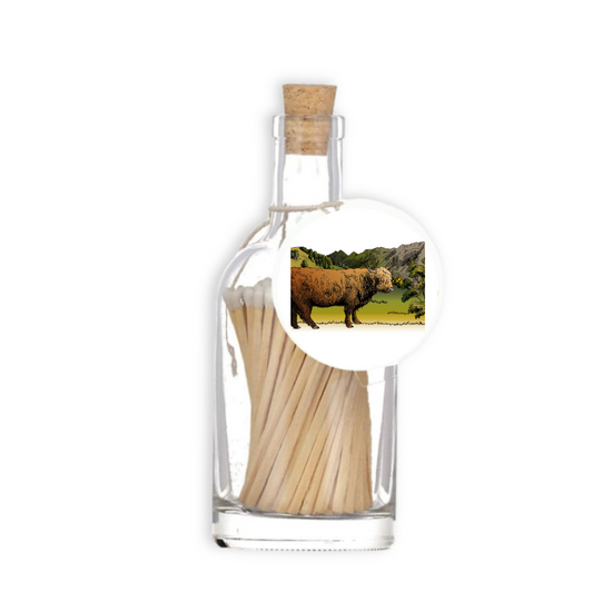 A luxury glass match bottle from the Home County Co. with Highland Cow illustrated gift tag.