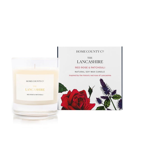 A red rose and patchouli scented soy wax candle inspired by Lancashire is shown next to its sustainable candle box with red rose illustration