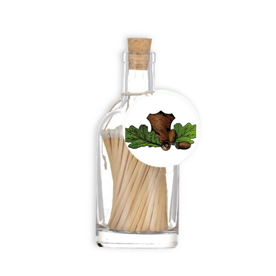 A luxury glass match bottle from the Home County Co. with Leather and Acorn illustrated gift tag.