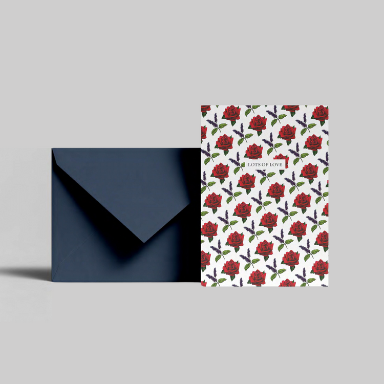 A red rose illustrated greeting card with lots of love message from the Home County Co. is shown with its navy envelope.
