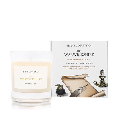 A parchment and quill scented soy wax candle inspired by Warwickshire is shown next to its sustainable candle box with parchment and quill illustration