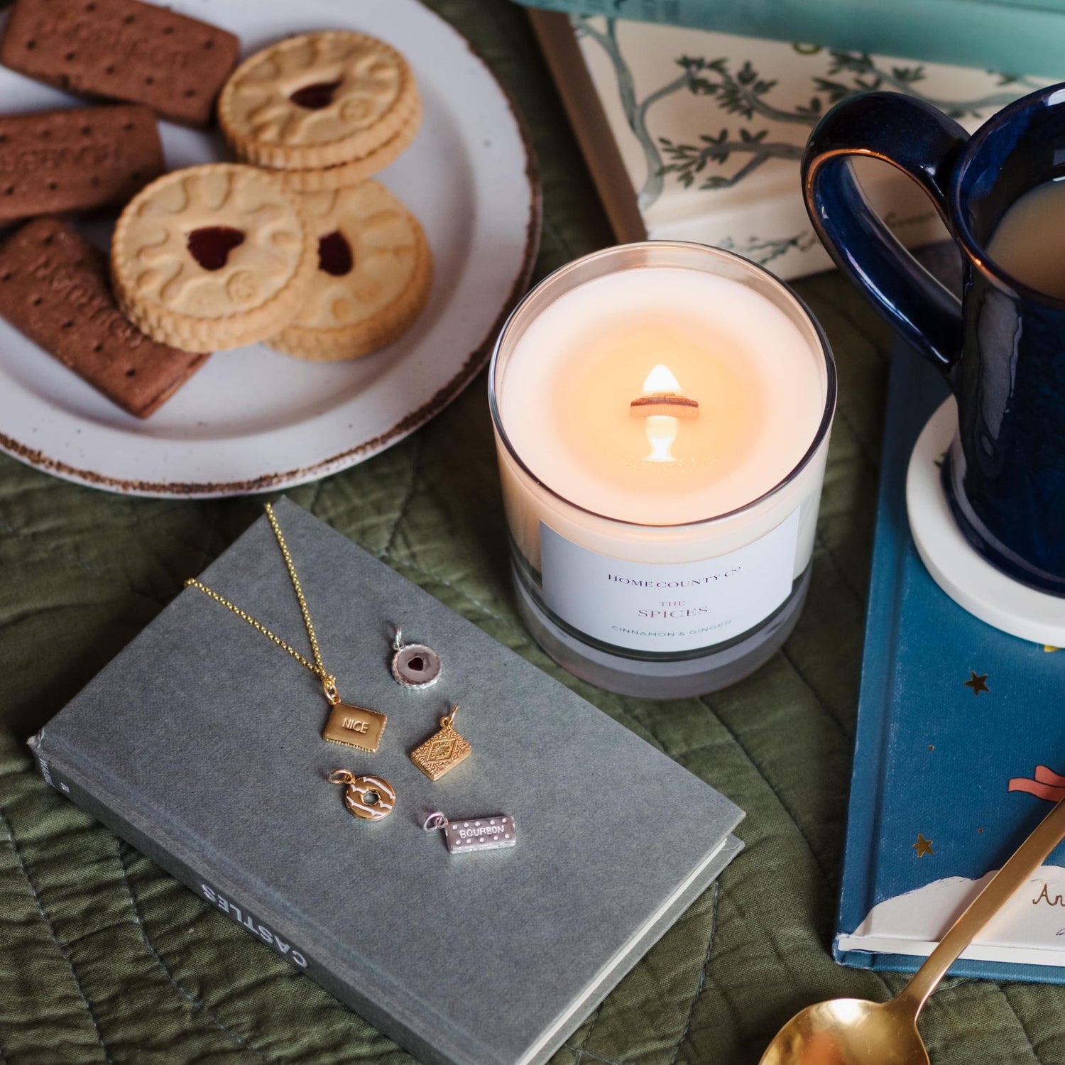 Home County Co. soy candle is shown with its wooden wick lit