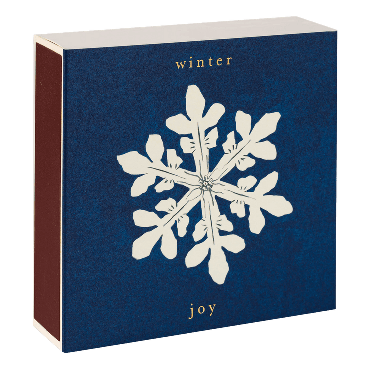 A box of Archivist matches with a Winter Joy snowflake design is shown closed with striker on the side.