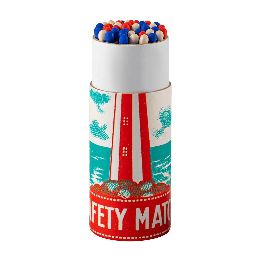 A cylinder box of Archivist matches with nautical lighthouse design and strike a light message is shown open with red, white and blue tips