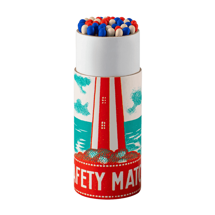 A cylinder box of Archivist matches with nautical lighthouse design and strike a light message is shown open with red, white and blue tips