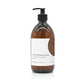 A 300ml woody scented liquid hand wash from the Home County Co. is shown in its recyclable amber glass hand wash bottle.