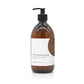 A 500ml woody scented liquid hand wash from the Home County Co. is shown in its recyclable amber glass hand wash bottle.
