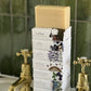 A stack of Home County Co. county soap bars is shown on a bathroom sink