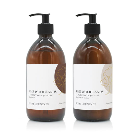 A 500ml woody cedarwood and jasmine scented hand wash and lotion duo from the Home County Co. is shown in eco-friendly amber glass bottles