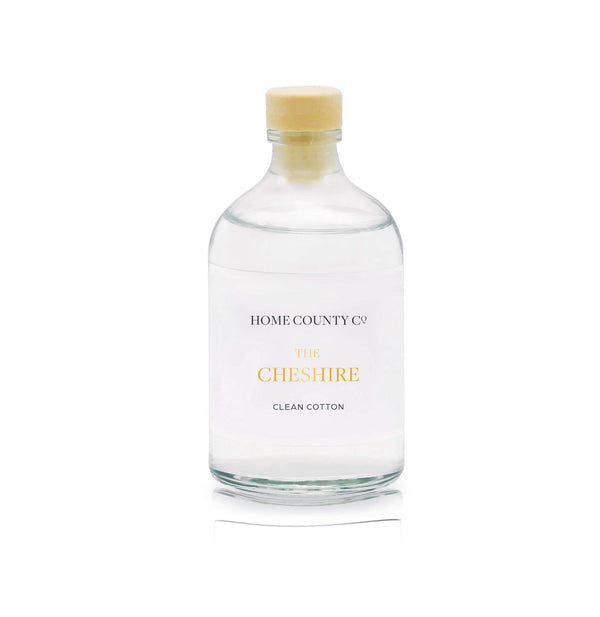 A clean cotton reed diffuser refill is shown in a recyclable glass bottle