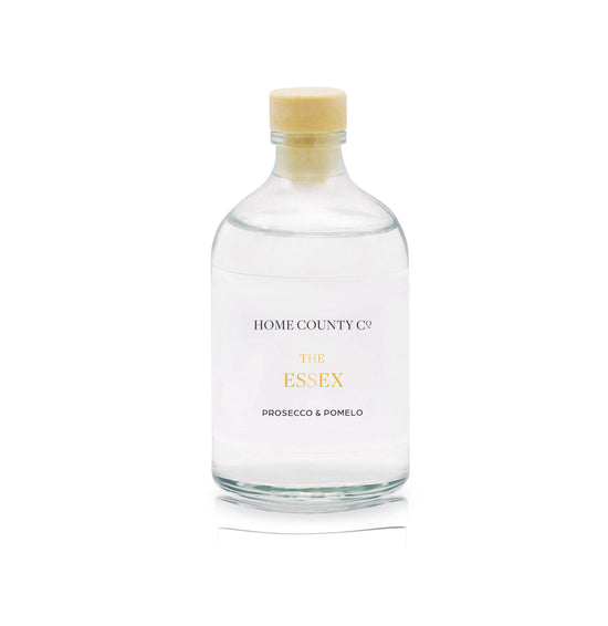 A prosecco and pomelo reed diffuser refill is shown in a recyclable glass bottle