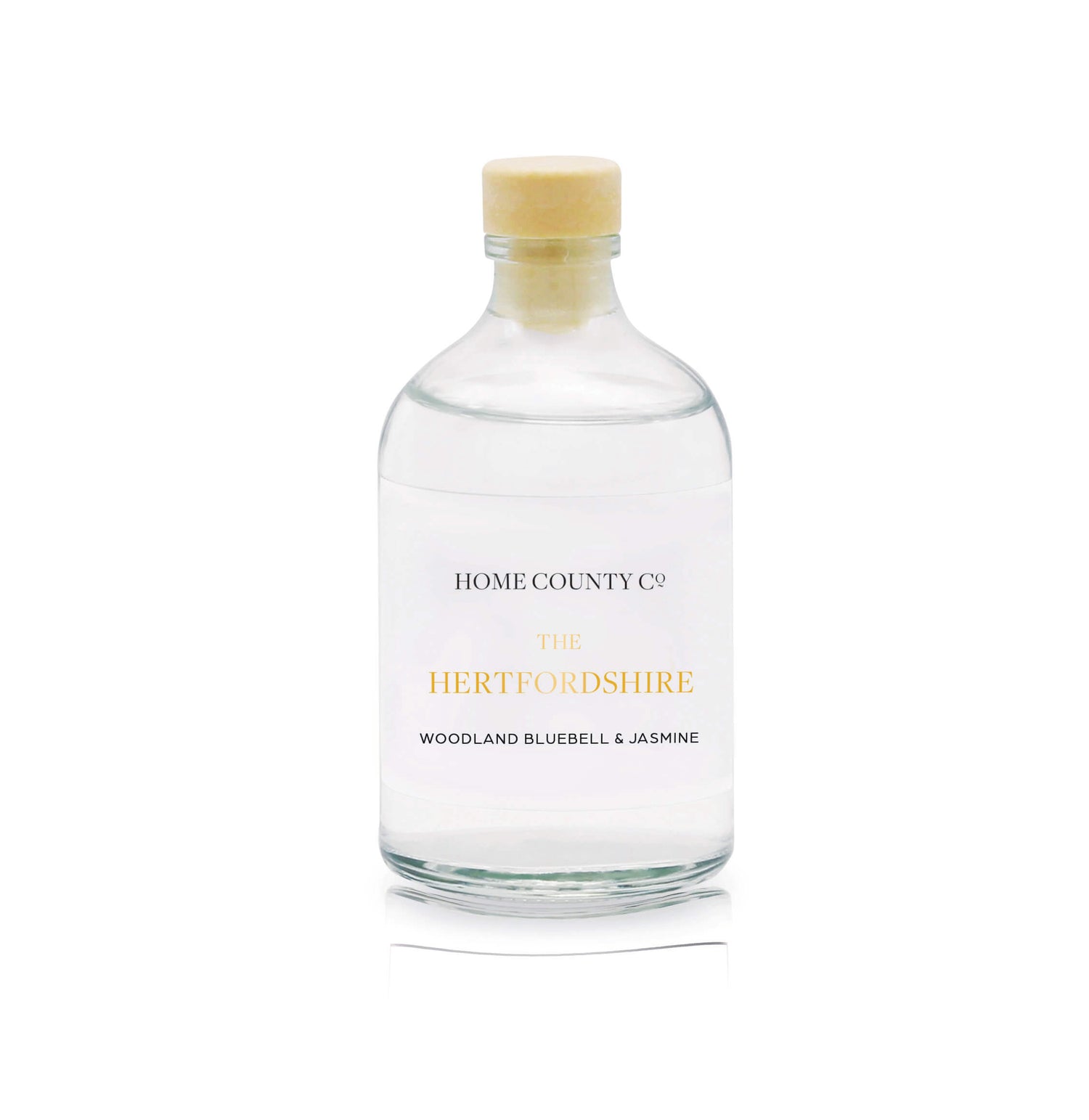 A woodland bluebell and jasmine reed diffuser refill is shown in a recyclable glass bottle