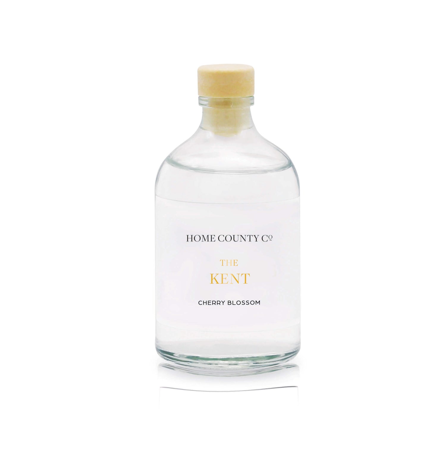 A cherry blossom reed diffuser refill is shown in a recyclable glass bottle